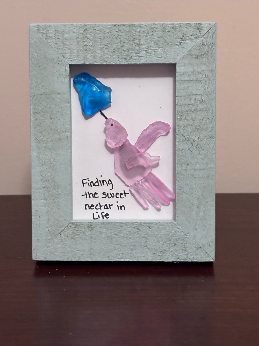 Handcrafted Pink Sea Glass Hummingbird Art with Blue Flower in a Blue Wood Frame